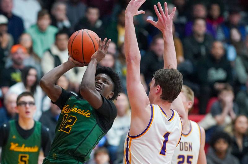 Waubonsie Valley's Tyreek Coleman (12) shoots the ball in the post against Downers Grove North's Jake Riemer (1) during a Class 4A East Aurora sectional semifinal basketball game at East Aurora High School on Wednesday, Feb 28, 2024.