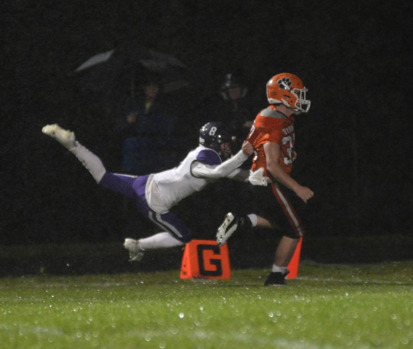 Dixon's Tyson Dambman (8) tries unsuccessfully to keep Byron's Caden Considine (37) out of the end zone during first quarter action on Friday, Oct. 13, 2023 at Byron High School's Everett Stine Field.