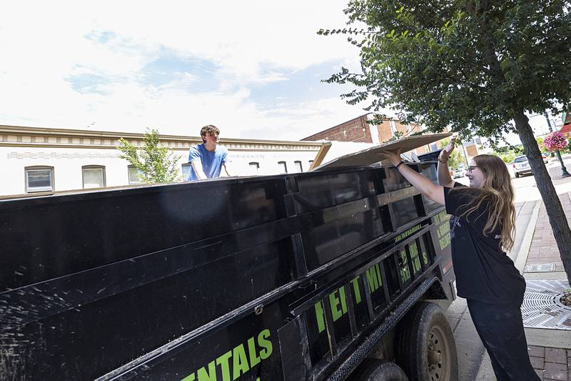 Dixon Stage Left volunteers Bradlee Koenig (left) and Jodie Lawson throw old ceiling tiles into a trailer for disposal Wednesday, July 3, 2024.