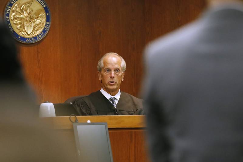 Judge Michael Coppedge talks to the attorneys during Nathan Rigg’s jury trial Tuesday, Aug. 30, 2022, in the McHenry County courthouse in Woodstock. Rigg was charged with two counts of predatory criminal sexual assault of a child younger than age 13, a Class X felony. Rigg was accused of sexually abusing a 4-year-old child in 2019, according to court records. The case was investigated by the Woodstock Police Department, and a warrant was issued for his arrest in March 2020.