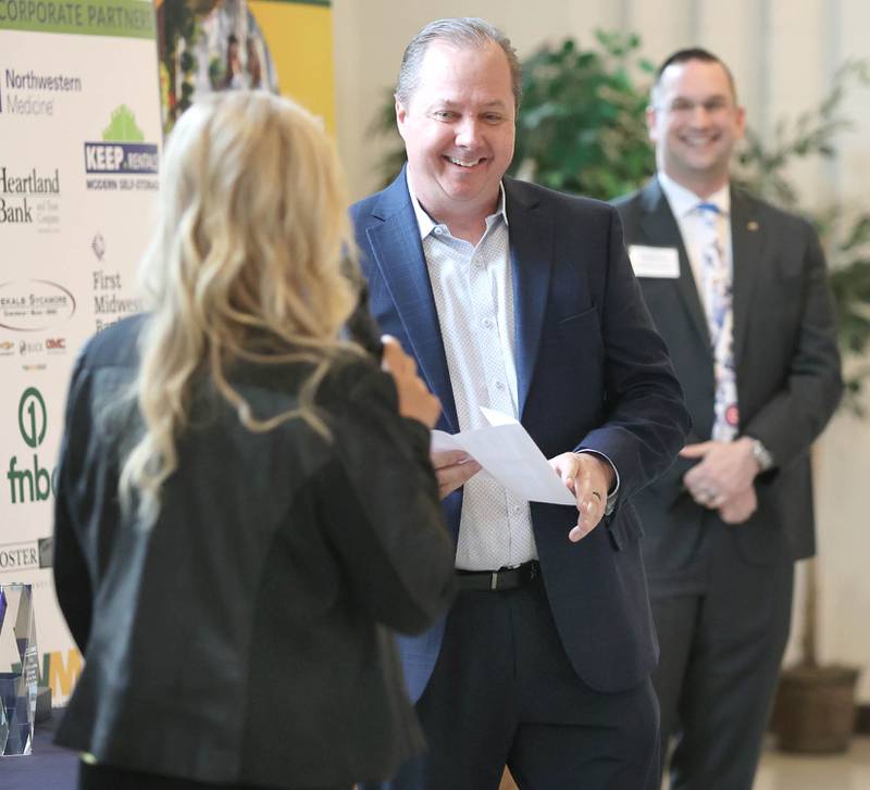 John Huddleston, director of Upstaging, Inc., accepts the Outstanding Business of the Year Award from Robert Heck, (right) Sycamore Chamber of Commerce board president, and RoseMarie Treml, chamber executive director, during the chambers annual meeting Thursday, April 7, 2022, at St. Mary Memorial Hall in Sycamore.