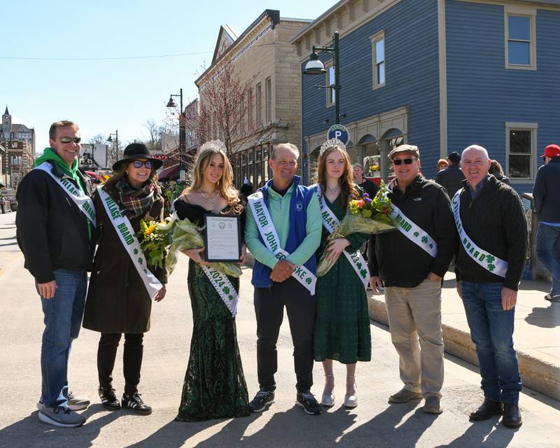 Mayor of Lemont John Egofske, center, pose for a photo with the 2024 St. Patrick’s Parade queen Brayah Bromberck, third from left, 2023 St. Patrick’s parade queen, third from right along with villiage Board members before the start of the St. Patrick’s Parade on Mark 9, 2024, in downtown Lemont.