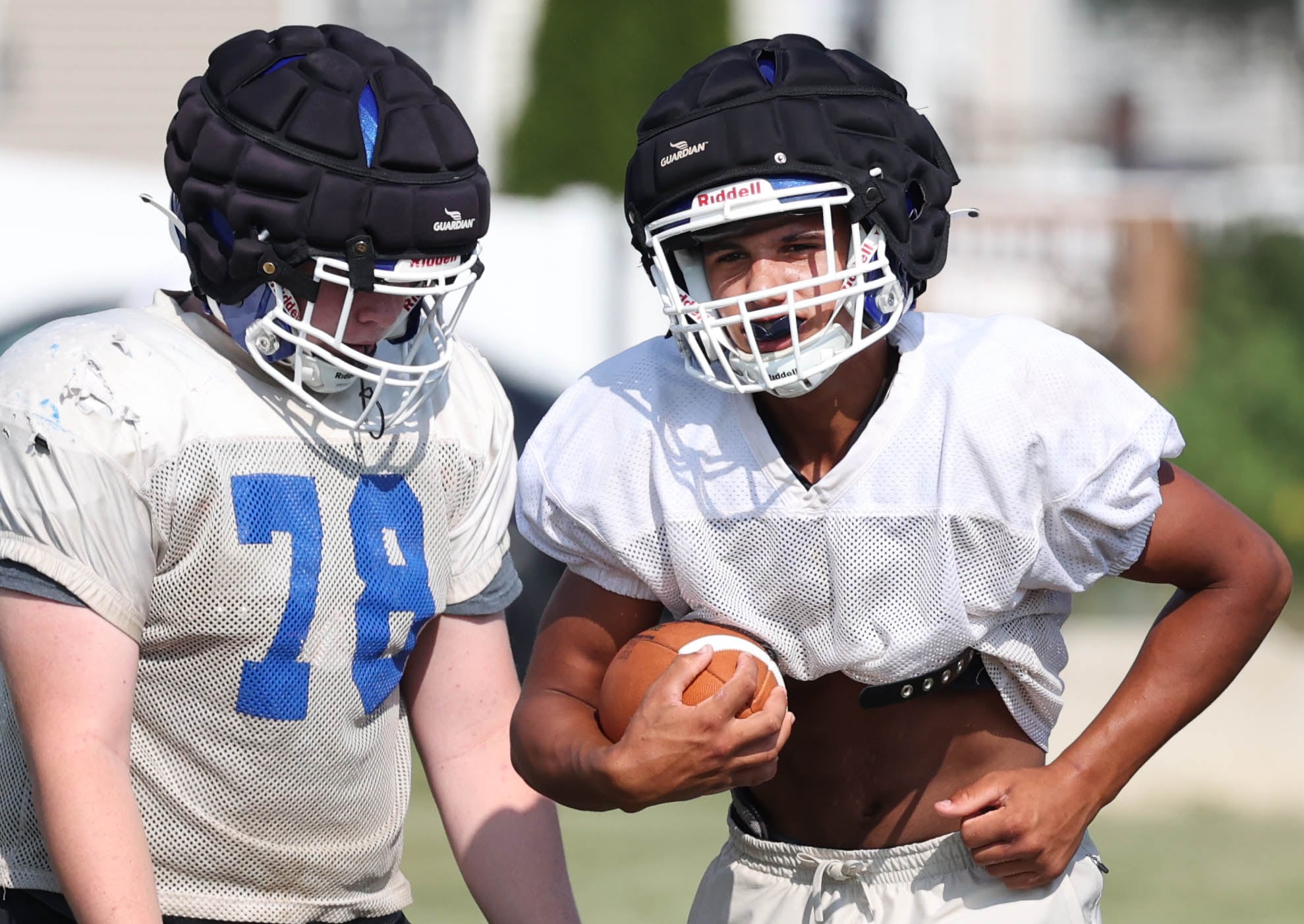 Genoa-Kingston’s Tyler Atterberry (right) carries the ball during practice Wednesday, Aug. 14, 2024, at the school in Genoa.