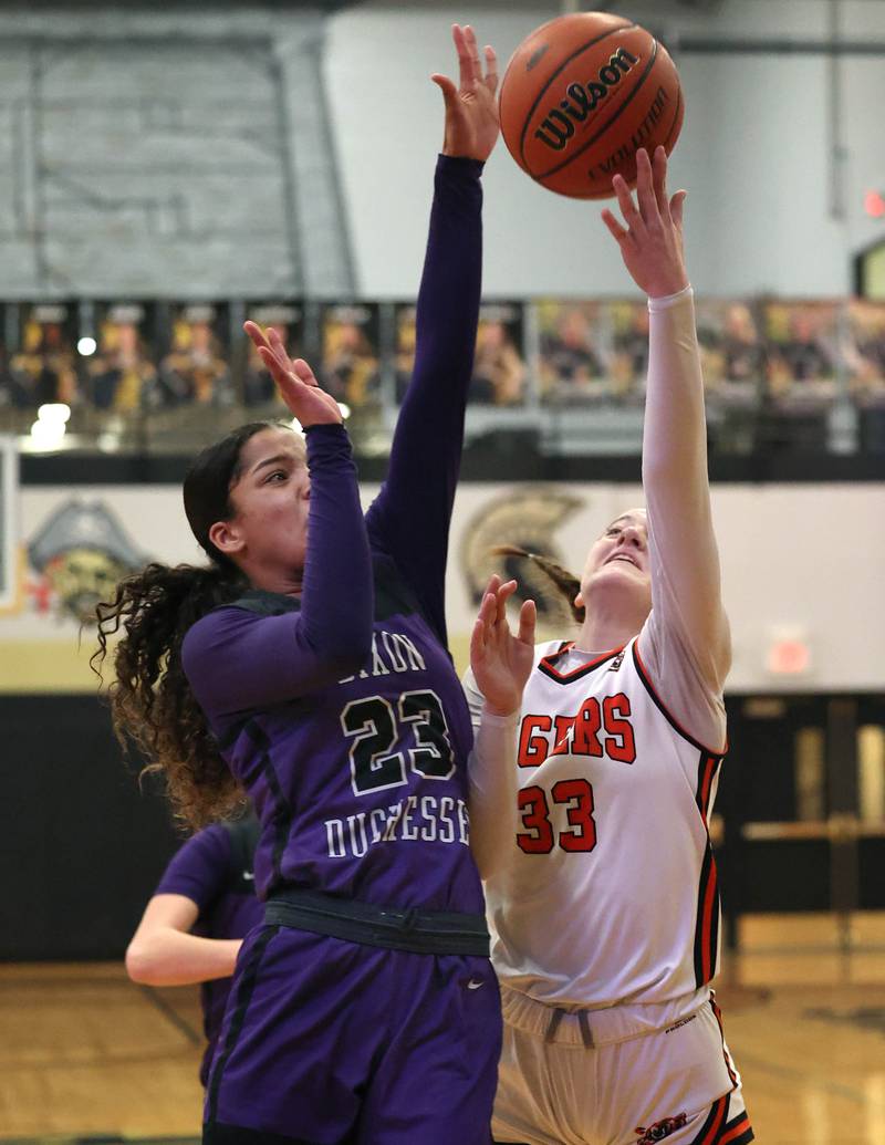 Dixon’s Ahmyrie McGowan blocks the shot of Crystal Lake Central's Katie Hamill during their Class 3A sectional semifinal Tuesday, Feb. 20, 2024, at Sycamore High School.