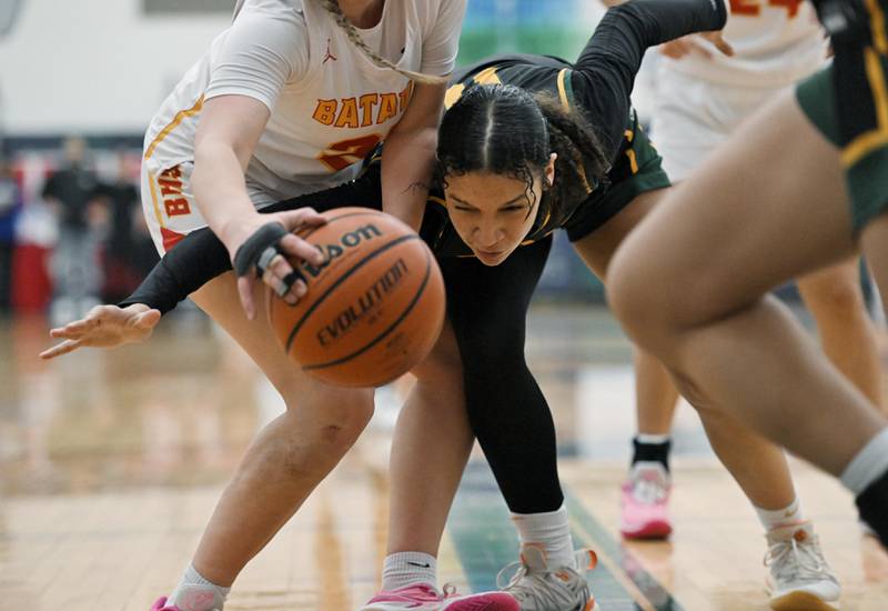 Fremd’s Coco Urlacher battles for the ball under the basket against Batavia’s Kylee Gehrt  in the Bartlett supersectional game on Monday, Feb. 26, 2024.