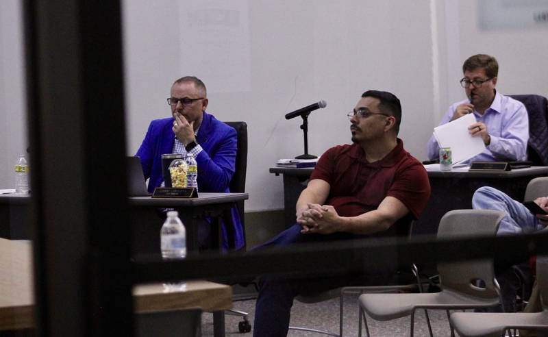 Seen through the glass doorway to the Dixon City Council chambers, former Dixon mayor Li Arellano Jr. takes a seat in the audience for the remainder of the meeting on Monday, May 1, 2023.