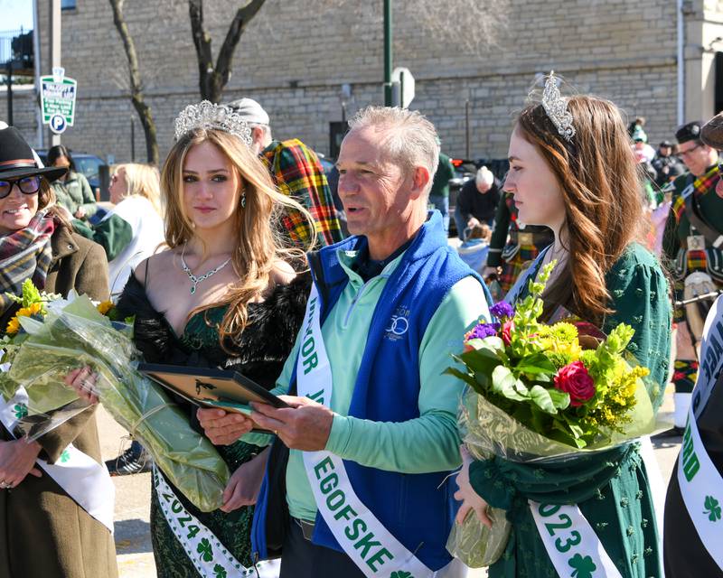 Mayor of Lemont John Egofske, center, presents a plaque to Brayah Bromberck, right, the 2024 St. Patrick’s Day Queen with Sea Manning who was the 2023 St. Patrick’s Day Queen held on Saturday March 9, 2024, in downtown Lemont.