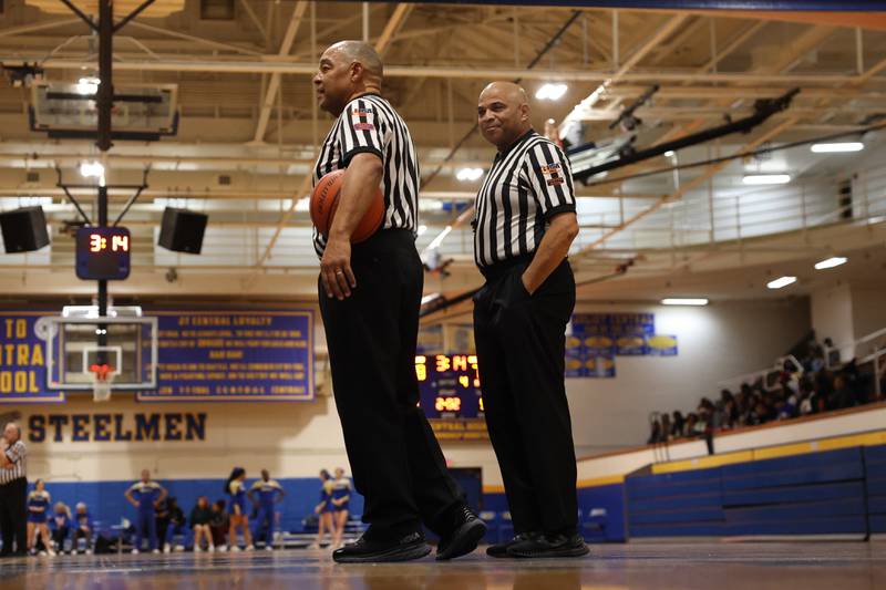 IHSA referees stand by during a timeout at the game between Joliet Central against Joliet West.