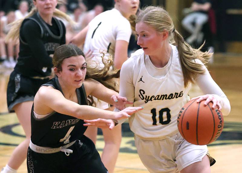 Sycamore's Lexi Carlsen tries to drive by Kaneland's Madison Schrader during their Class 3A sectional semifinal Tuesday, Feb. 20, 2024, at Sycamore High School.