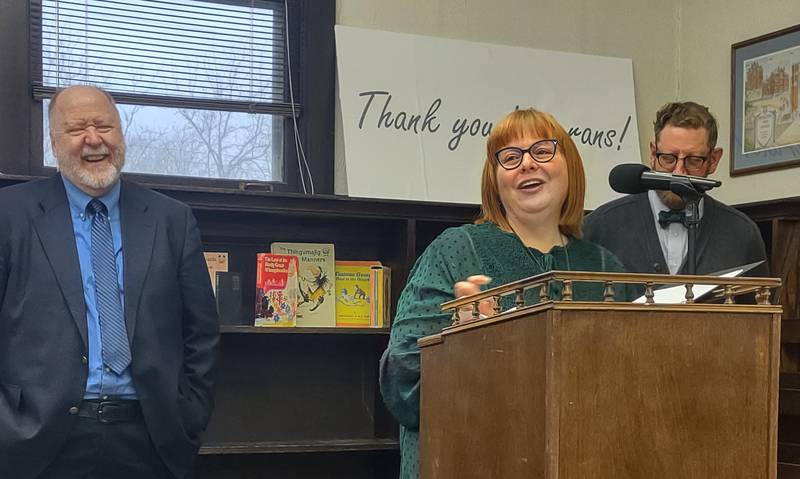 Angela Adams (left) announces True Leaves Bookshop, which she co-owns with her husband Matthew (right), will relocate to the former Matson Public Library building on Park Avenue West in Princeton during an open house on March 22, 2024. The building will join the Bureau County History Center campus later this year.