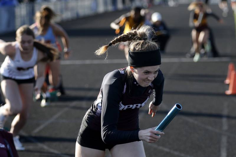 Prairie Ridge’s Molly Willis leads off the 4x100 meter relay for her team Friday, April 21, 2023, during the McHenry County Track and Field Meet at Cary-Grove High School.