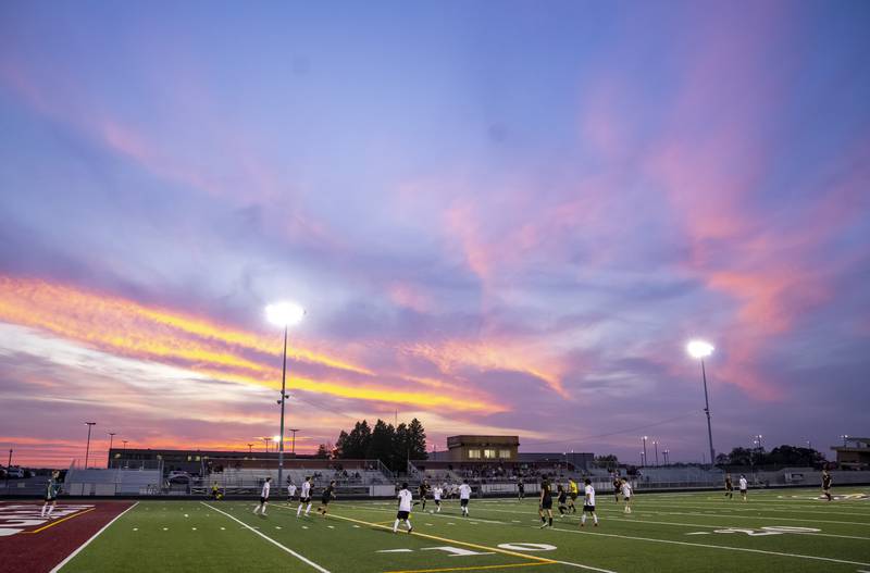 Richmond-Burton and Woodstock North play under a sunset during their varsity soccer game on Wednesday, September 18, 2024 at Richmond-Burton High School in Richmond. Ryan Rayburn for Shaw Local