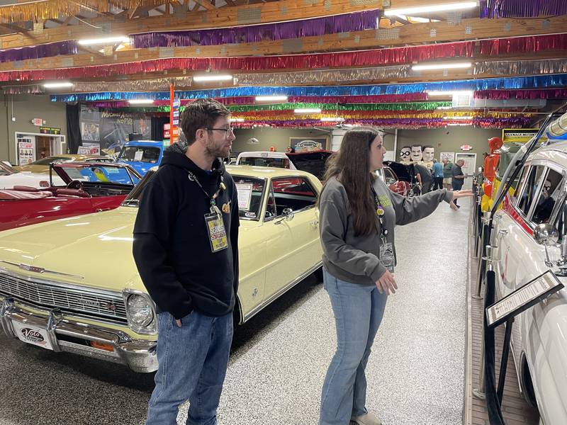 Guides Seamus Pearcy and Jordan Burg pause by the Volo Museum's Ecto-1 during a guided tour of the Volo Museum. Tours offering insider lore and behind-the-scenes access are now available Tuesdays and Thursdays, included with museum admission.