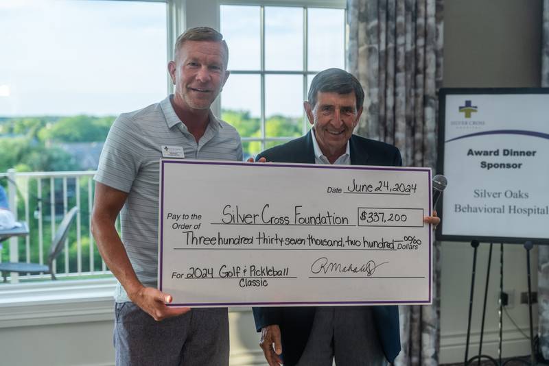 Silver Cross President and CEO Michael Mutterer (left) presents the 2024 Silver Cross Corporate Citizen Award to Rudy Mahalik, Jr., President and Owner of PDM Plumbing, Heating & Cooling (right) at the 33rd Annual Silver Cross Charity Golf & Pickleball Classic held June 24 at Crystal Tree Golf and Country Club. The annual outing raised a record-breaking $337,000 to advance patient care at Silver Cross Hospital.