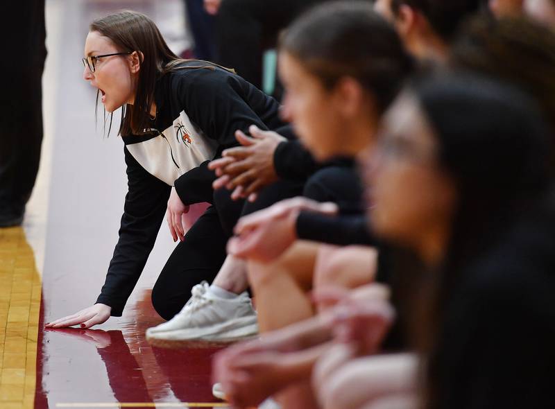 St. Charles East head girls basketball coach Katie Claussner slaps the floor while shouting to her team during the Montini Christmas Tournament championship game against Montini on Dec. 29, 2023 at Montini Catholic High School in Lombard.