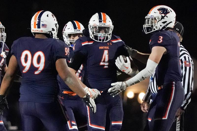 Oswego’s Easton Ruby (4) is greeted by his team mates after intercepting a pass against Minooka during a football game at Oswego High School on Friday, October 18, 2024.