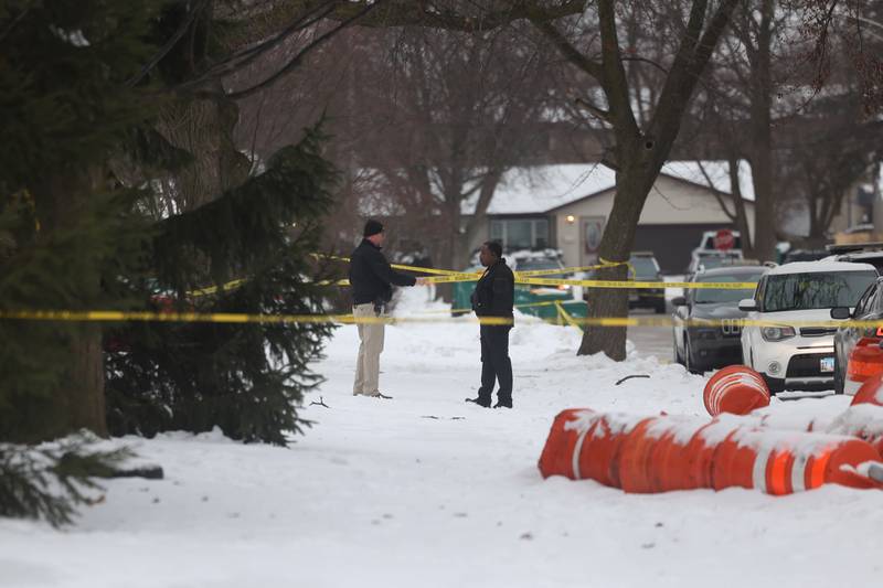 Joliet Police officers outside a home along West Acres Road at the scene were multiple people were found dead in two homes on Monday, Jan. 22nd in Joliet.