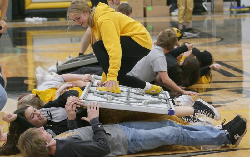 Putnam County student Megan Wasilewski surfs on-top of a table during the table surfing game at the Football Homecoming Pep Rally on Thursday, Oct. 6, 2022 at Putnam County High School in Granville.