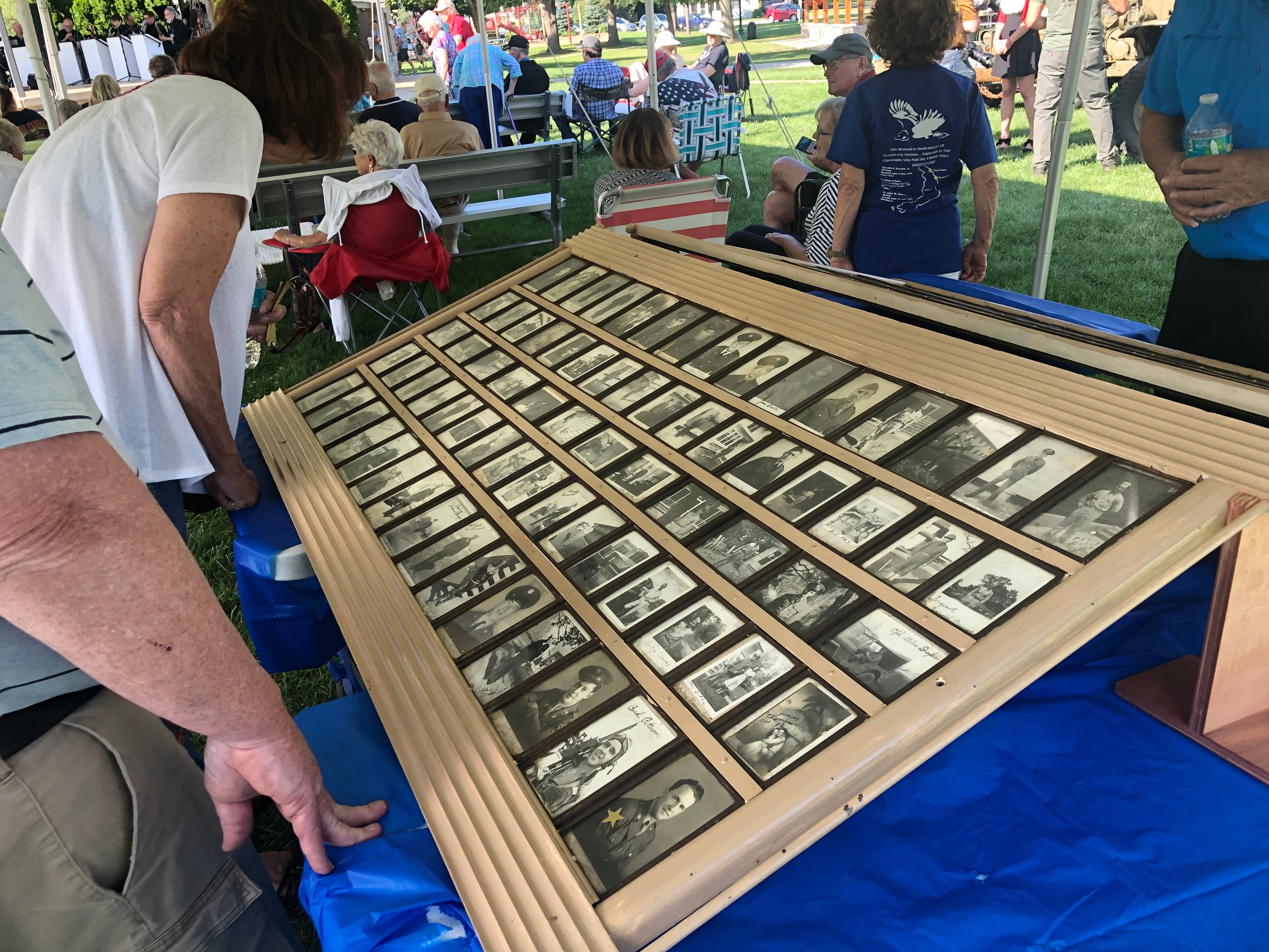 Those attending McHenry's annual Keep the Spirit of '45 Alive event on Sunday, Aug. 11, 2024, pour over World War II era photos. Originally hung at the Mi-Place Restaurant and Tavern, the photos will be relocated to the McHenry VFW Post 4600 once the proper location is found to hang them.