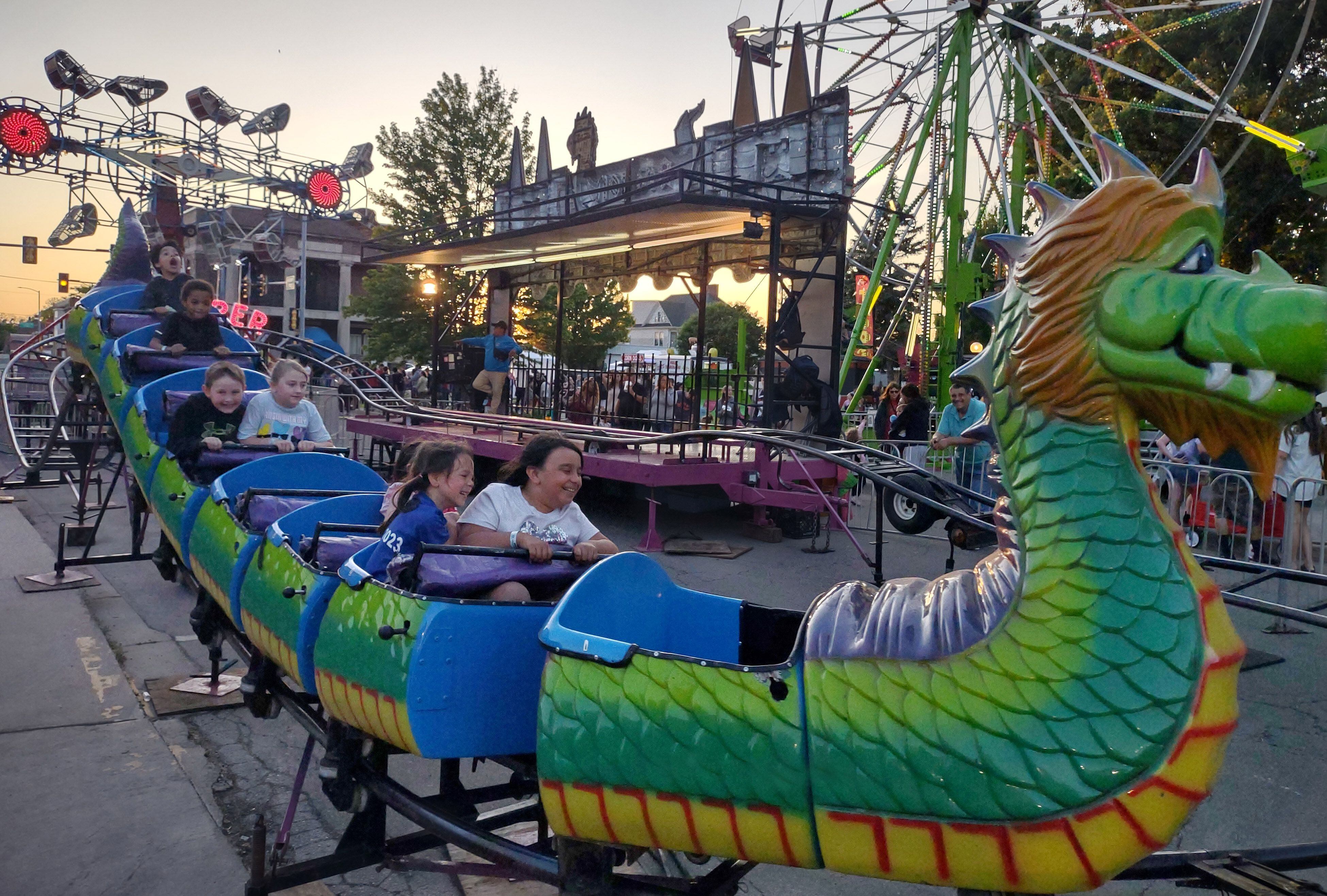 Children zoom along the track of the Dragon Wagon at Streator Park Fest on Friday, May 26, 2023.