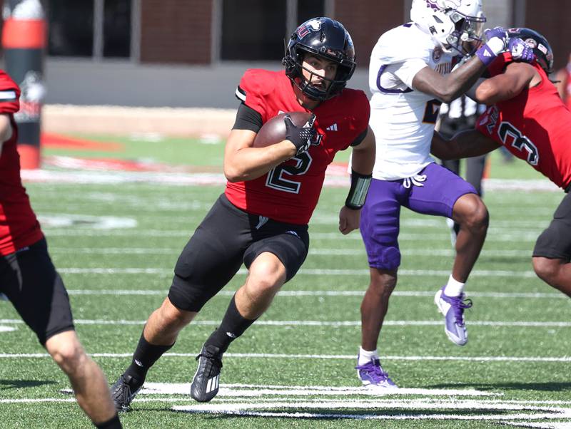 Northern Illinois quarterback Ethan Hampton finds some running room in the Western Illinois defensive line during their game Saturday, Aug. 31, 2024, in Huskie Stadium at NIU in DeKalb.