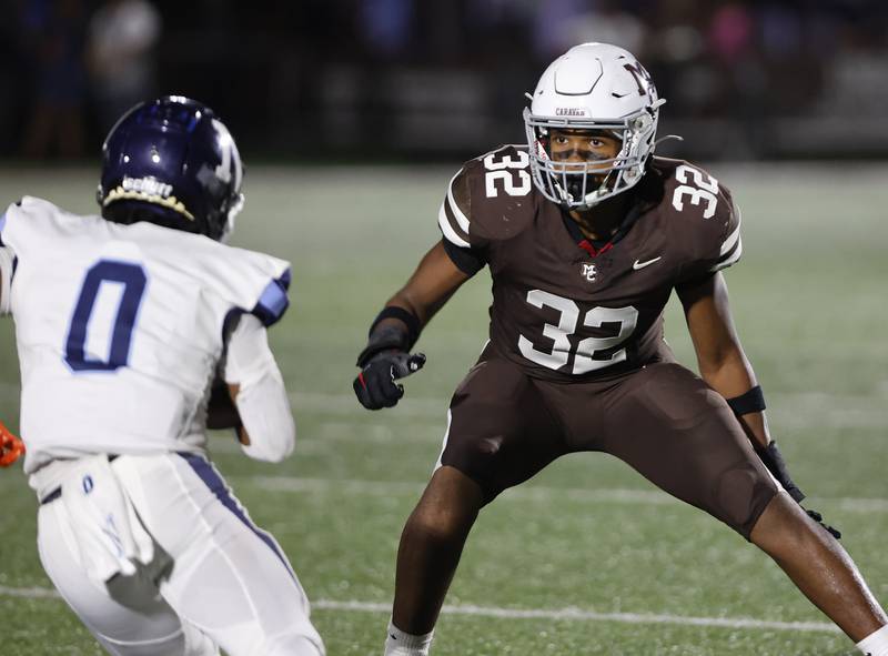 Nazareth's Edward McClain Jr. (0) tries to get around Mt. Carmel's Roman Igwebuike (32) during the varsity football game between Nazareth Academy and Mt. Carmel high school on Friday, Sep. 13, 2024 in Chicago.