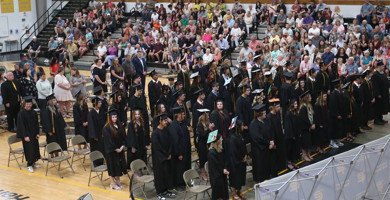 Putnam County High School graduates stand to be recognized during graduation on Sunday, May 19, 2024 at Putnam County High School.