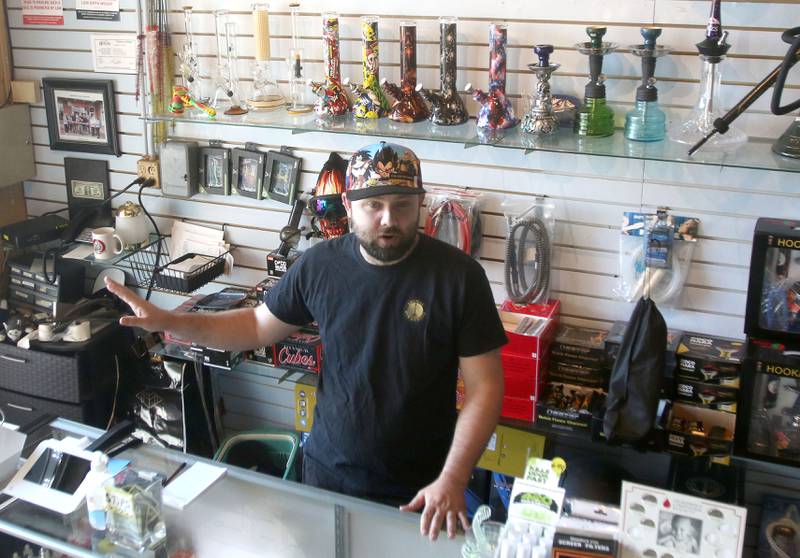 Cameron Dye, co-owner of Aroma's Hookah Bar in DeKalb, talks Tuesday in his shop about their plans as they soon will be able to allow patrons to bring their own marijuana in for smoking in the shop.