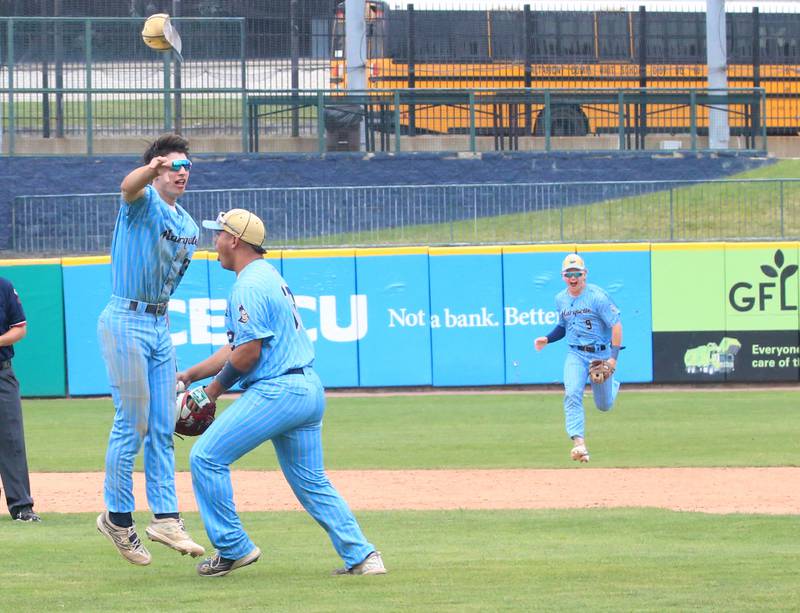 Marquette's Alec Novotney flings his cap in the air as teammates Sam Mitre and Caden Durdan celebrate after defeating Atlamont to win the Class 1A State championship title in June at Dozer Park in Peoria.