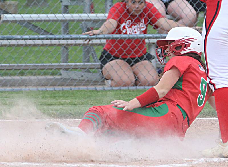 L-P's Allie Thome slides into home safely on a pass ball against Streator during the Class 3A Regional semifinal game on Tuesday, May 21, 2024 at Metamora High School.