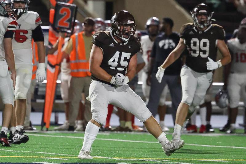 Joliet Catholic’s Nick Bueno celebrates a sack against Iowa City on Friday, August 30, 2024 in Joliet.