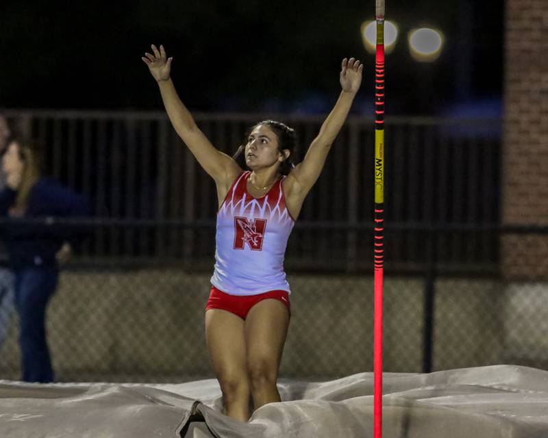 Naperville Central's Athena Ghiotto reacts after clearing the bar in the pole vault at Friday's Class 3A Downers Grove North Sectional track and field meet.