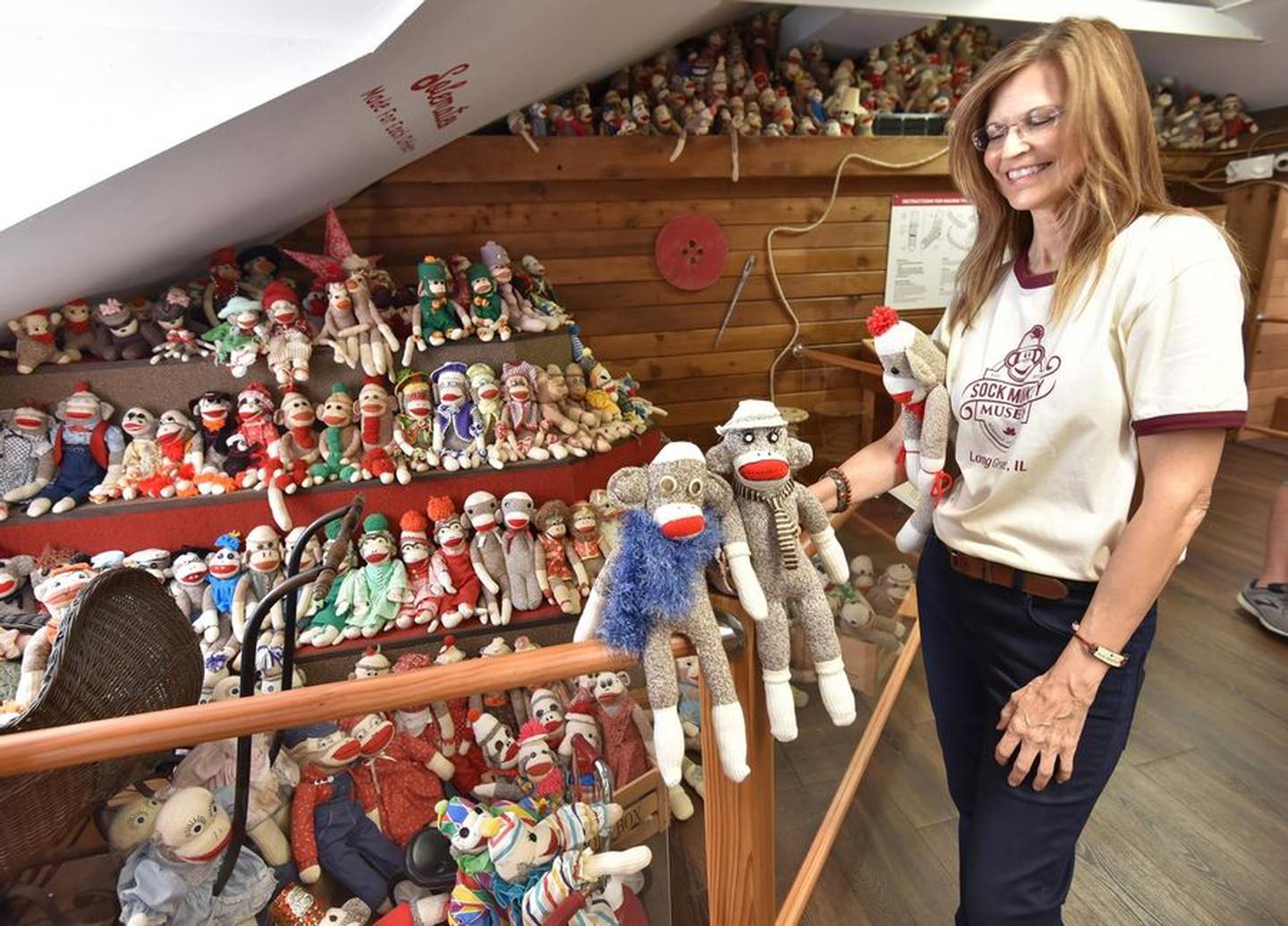 Sock Monkeys are counted by Guinness World Records representatives Chloe McCarthy, left, and Hannah Ortman at the Sock Monkey Museum in Long Grove on Thursday. The museum officially set the world record with 2,098 sock monkeys.