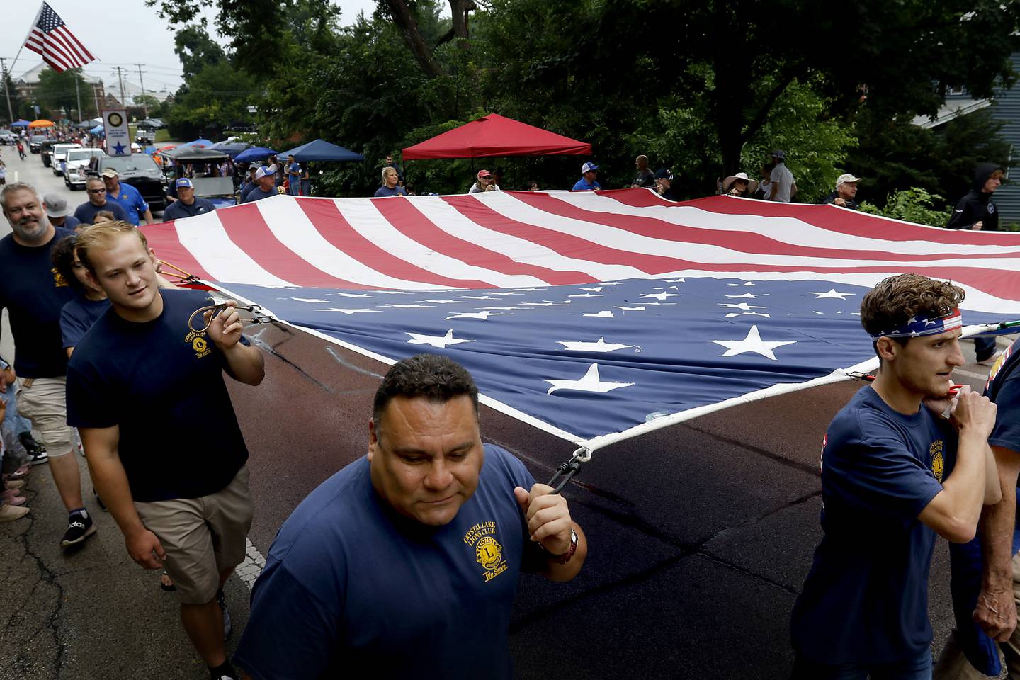 Members of the Crystal Lake Lions Club carry a large American Flag Sunday, July 2, 2023 during Crystal Lake’s annual Independence Day Parade on Dole Avenue in Crystal Lake. This year’s parade feature close to 100 units.