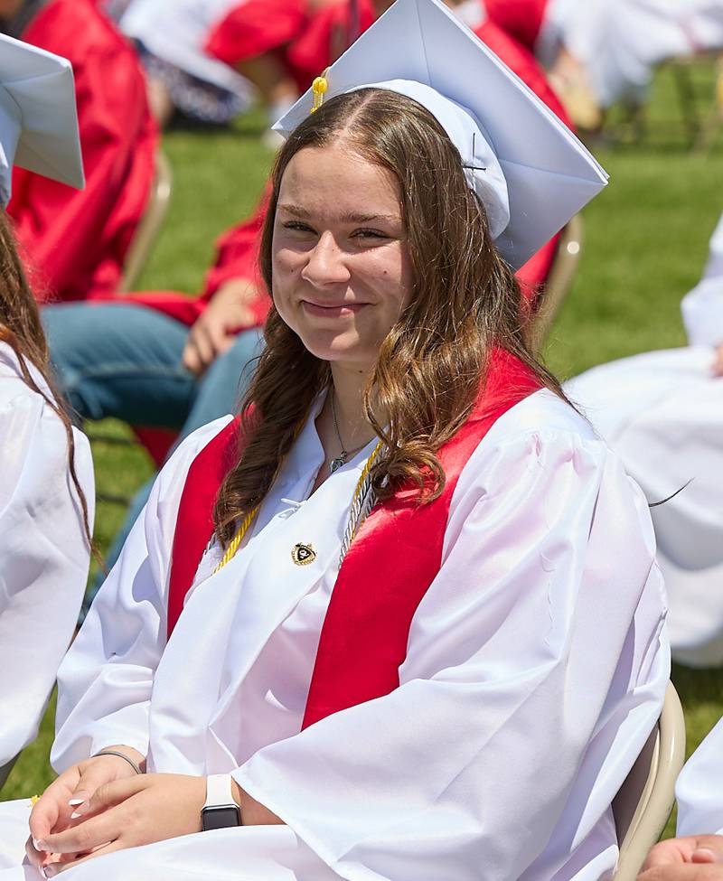 Hall graduate Takoda Dhesse smiles as she sits with the class of 2024 waiting for the ceremony to begin during graduation on Sunday, May 19, 2024 at Hall High School.