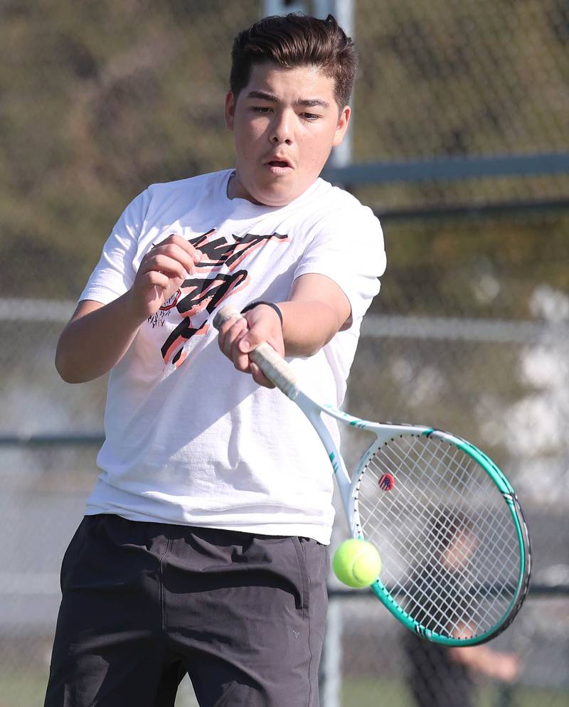 DeKalb number two doubles player Esteban Cardoso hits a forehand Wednesday, April 26, 2023, during their match at Sycamore High School.