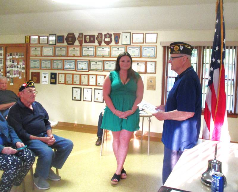 Granville Post 180 Commander, Ron Bluemer, (at far right) presents the Veteran’s Scholarship Award certificate to Erin Dove, who is the first student from St. Bede Academy to receive the award.