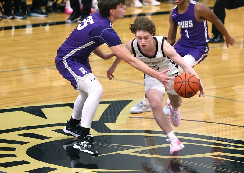 Sycamore's Preston Picolotti drives past Rochelle's Brode Metzger during their game Tuesday, Dec. 5, 2023, at Sycamore High School.