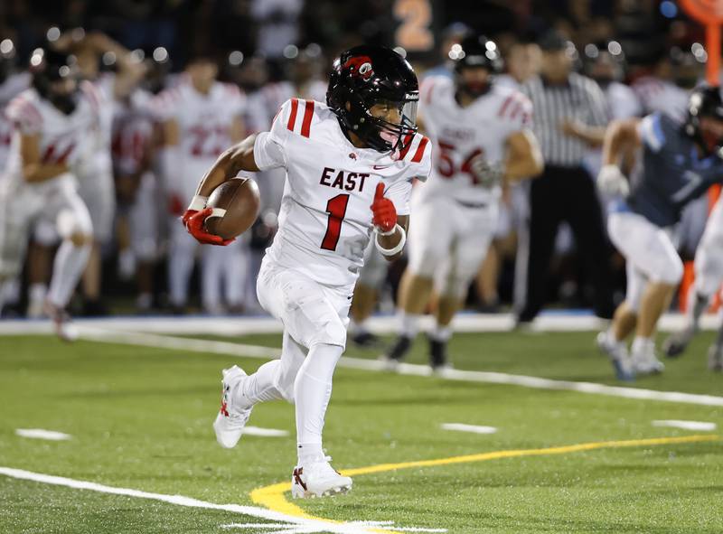 Glenbard East's Amonte Cook (1) runs the ball during the varsity football game between Glenbard East and Willowbrook high schools on Friday, Sep. 30, 2024 in Villa Park.