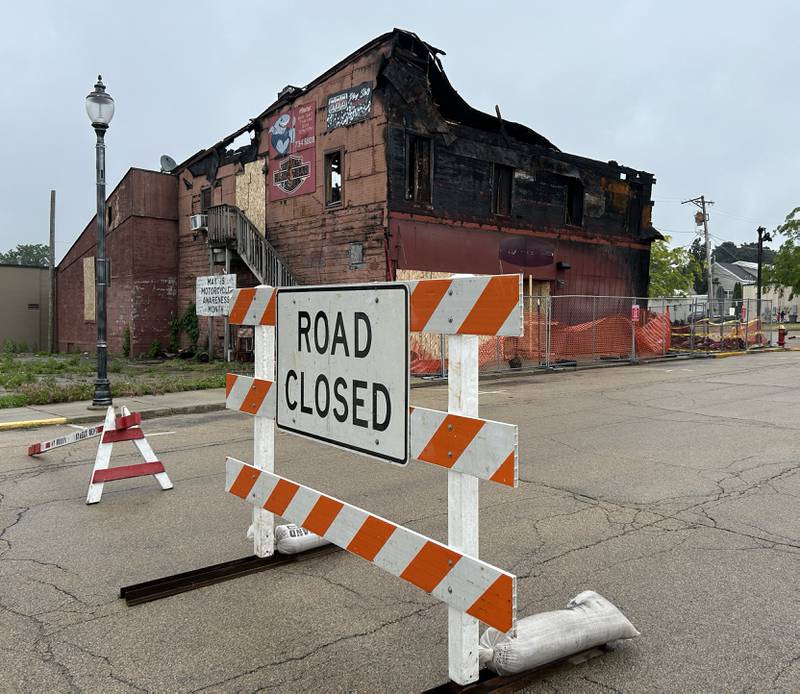 The charred building that once housed Sharky's Sports Bar on Wesley Ave., in Mt. Morris, remains standing Monday, June 3, 2024 following the April 16, 2024 fire that destroyed it and the adjacent building to the south  A portion of Wesley Ave. has been blocked off by the Mt. Morris Street Department.