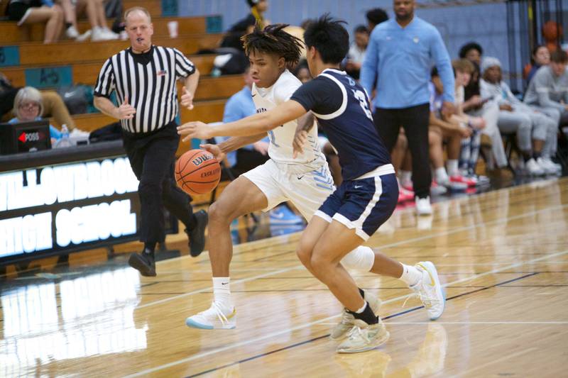 Willowbrook's Otis Powell advances the ball against Downer Grove South's Richard Gasmen on Friday, Feb.2,2024 in Villa Park.