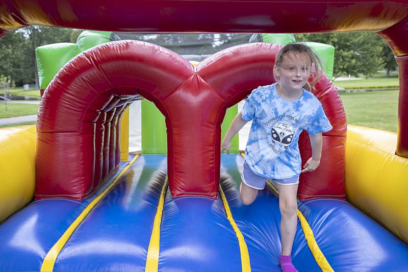 Evelyn Scanlan, 7, of Rock Falls comes out of an inflatable obstacle course Thursday, July 20, 2023 on the final day of the Coloma Park District field trip program. The program allowed campers to experience lots of fun activities and see many unique places.