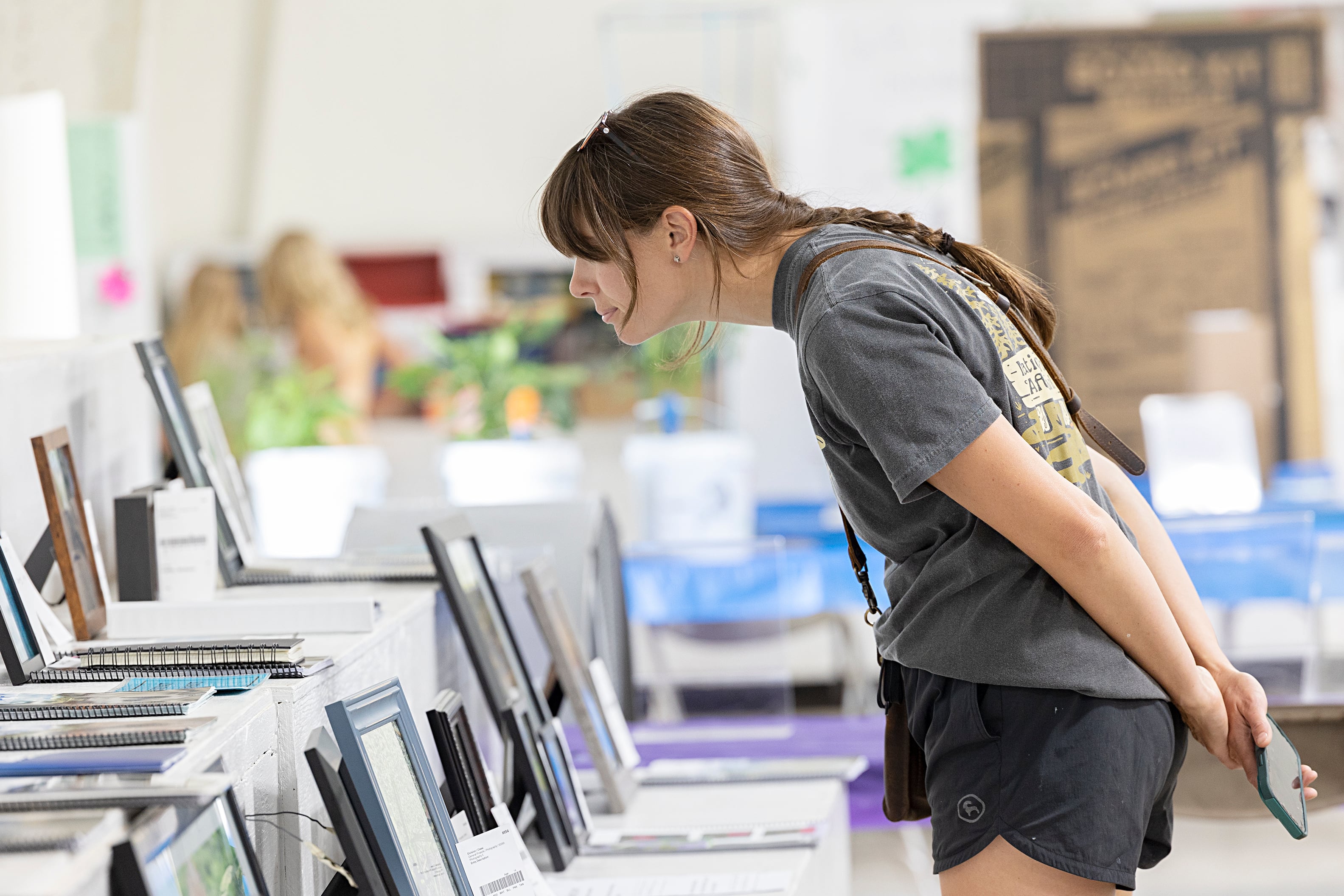 Janell Happ of Mendota checks out some photography on display Thursday, July 25, 2024 at the Lee County 4H Fair.