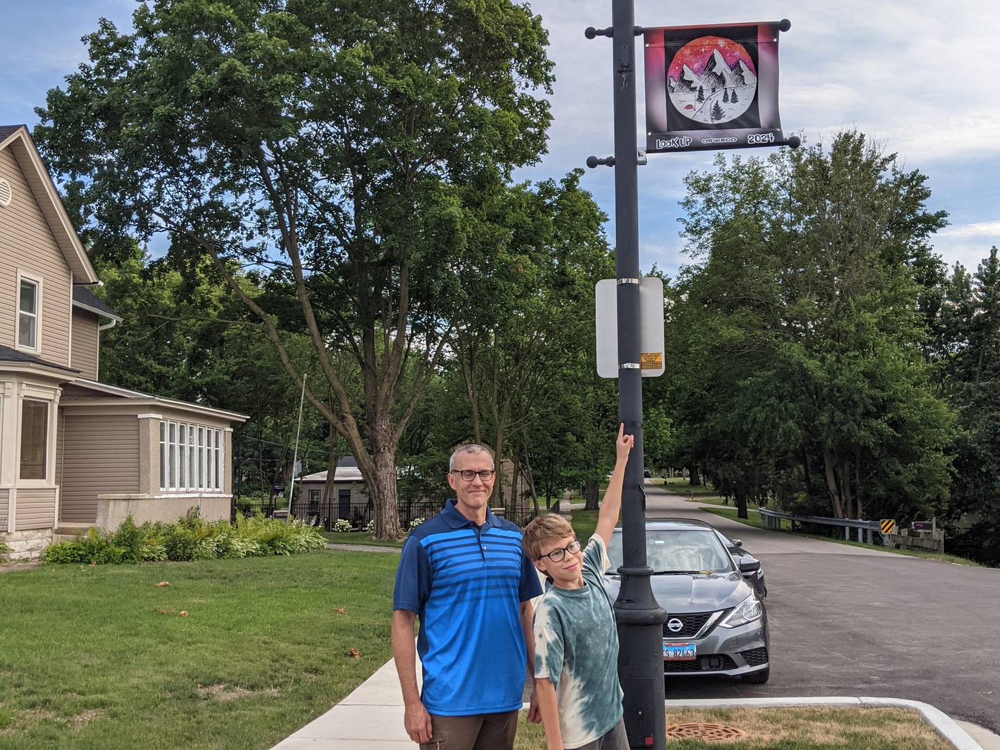 Joel Pierce, 11, who will attend Traughber Junior High School this fall, is happy to see his artwork on top of a light pole at the corner of Van Buren and Main streets in downtown Oswego.