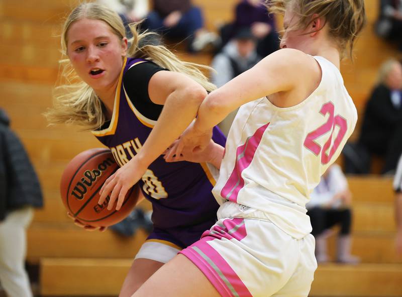 Downers Grove North’s Hope Sebek (10) goes up against Lyons Township’s Avery Mezan (20) during the girls varsity basketball game on Tuesday, Jan. 16, 2024 in La Grange, IL.