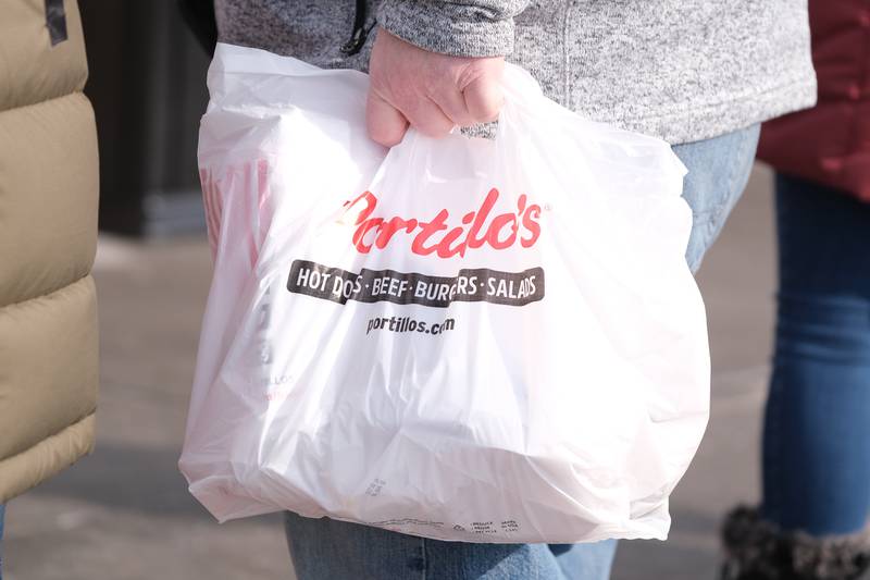 Frank Ramsey, of Romeoville, holds his Portillo’s order. Ramsey was the winner of Portillo’s “Portillo’s for a Year” contest. Tuesday, Feb. 1, 2022 in Joliet.