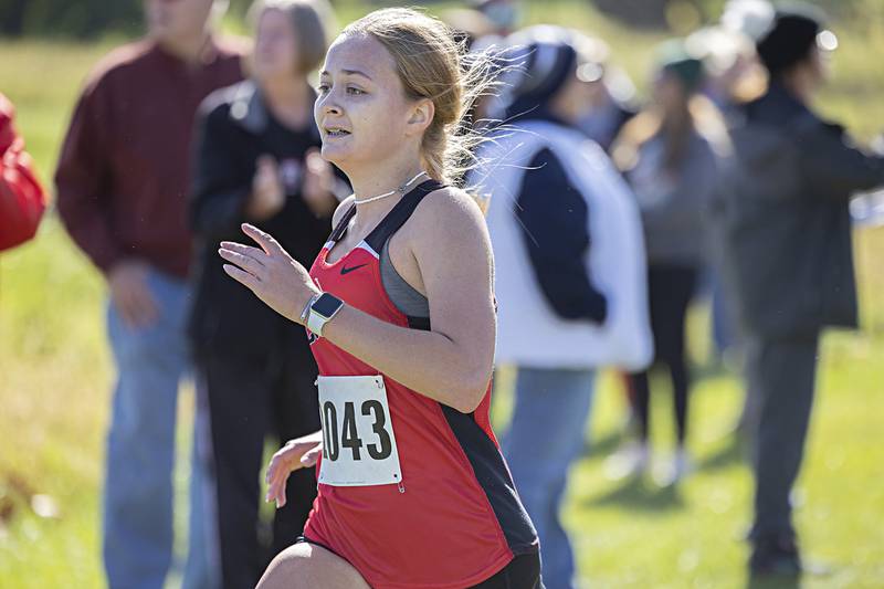 Amboy’s Anna Carlson eyes the finish line Monday, Oct. 9, 2023 during the 50th Amboy Columbus Day Cross Country Invite.