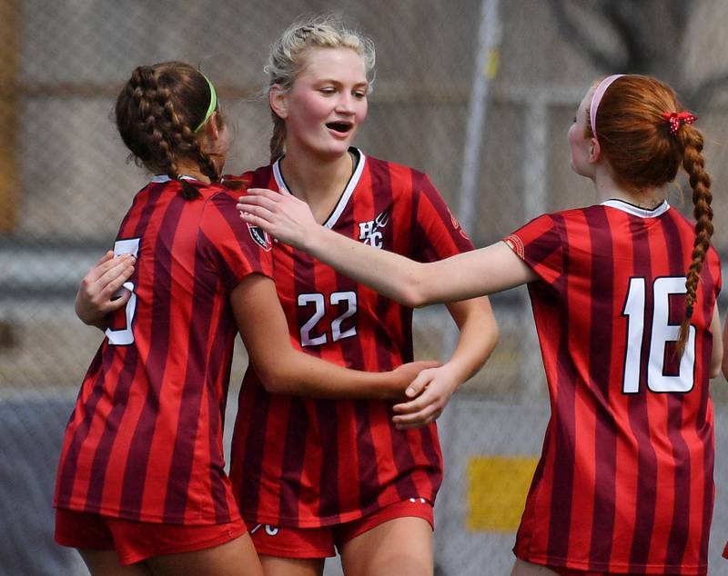 Hinsdale Central's Olivia Healy (22) celebrates with teammates after scoring the first goal during a match against Oswego East on March, 30, 2024 at Hinsdale Central High School in Hinsdale.