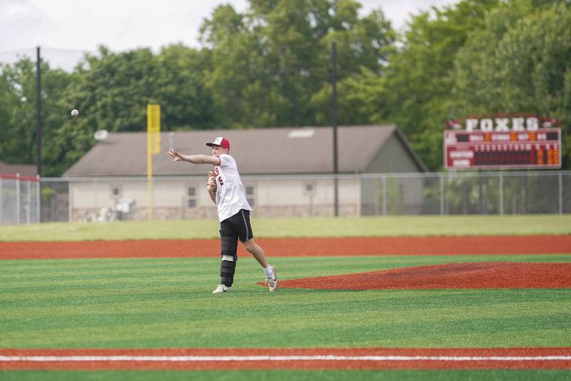 Yorkville's Simon Skroch (16) throws a ceremonial first pitch  before the start of a baseball game against Plainfield North at Yorkville High School in Yorkville on Thursday, May 16, 2024.