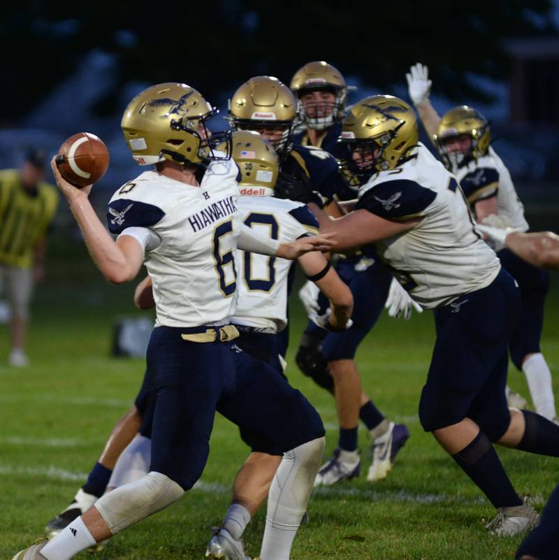 Hiawatha's Aidan Cooper drops back to pass the ball during 8-man football action against Polo on Friday, Sept. 13, 2024.